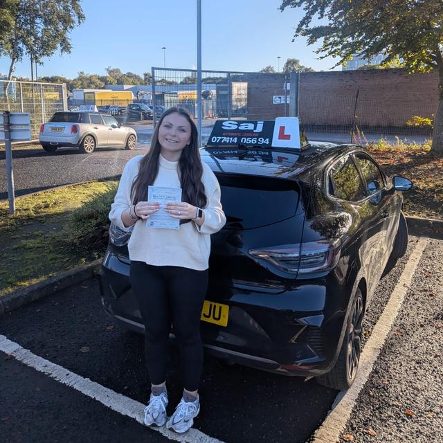 Pupil with pass certificate beside the Pull Up car