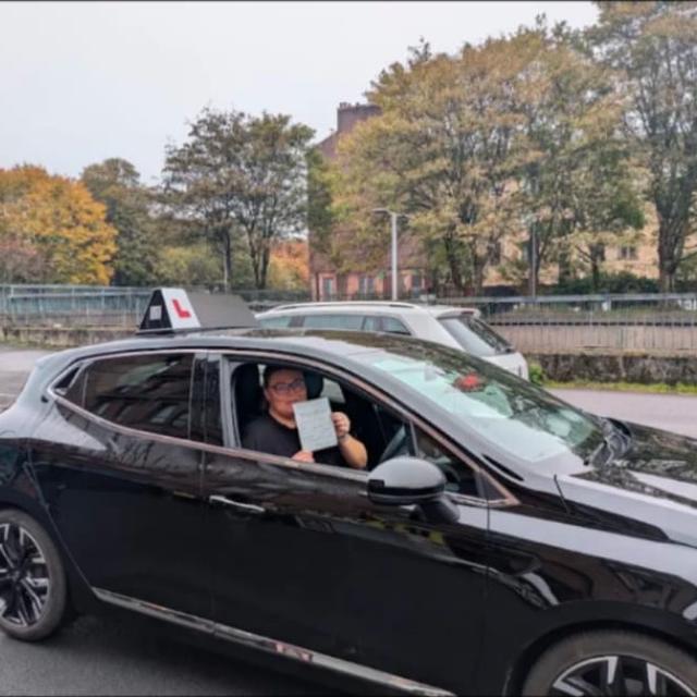 Pupil showing pass certificate from the driver's seat