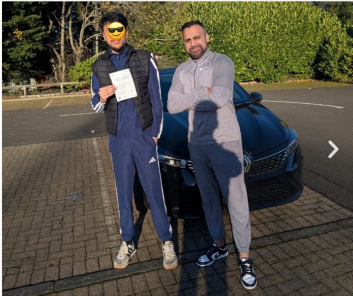 Pupil and instructor with pass certificate