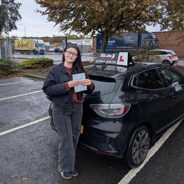 Pupil with pass certificate beside the Pull Up car